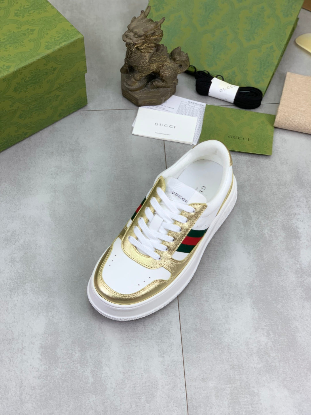 Gucci White Leather Sneakers with Gold Trim and Web Stripe
